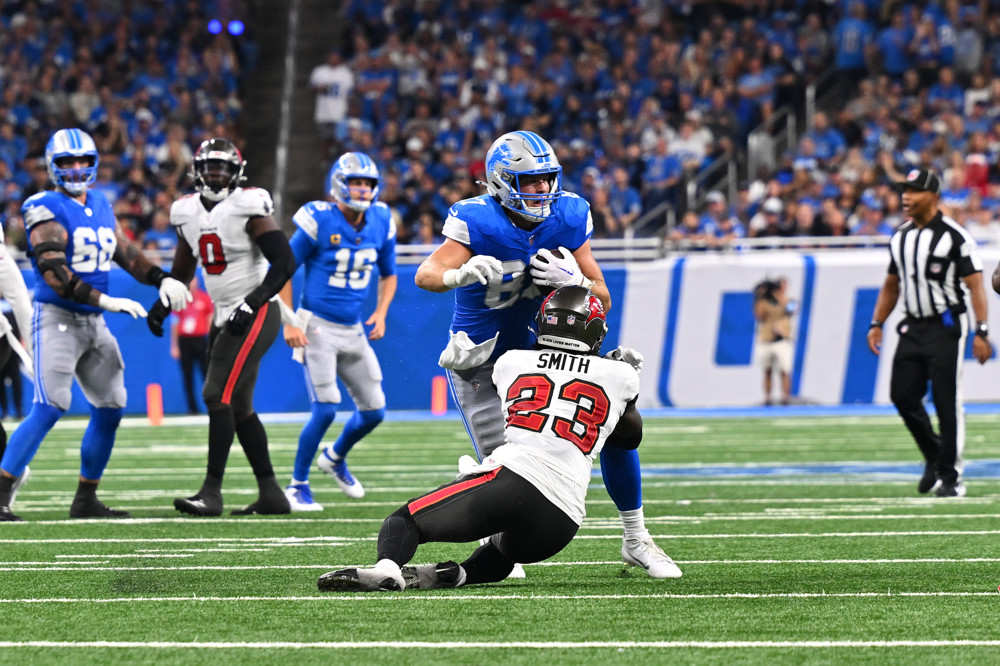 Tykee Smith (23) of the Tampa Bay Buccaneers tackles Sam LaPorta (87) of the Detroit Lions during an NFL game — featured in Week 2 IDP Start Sit fantasy football advice.