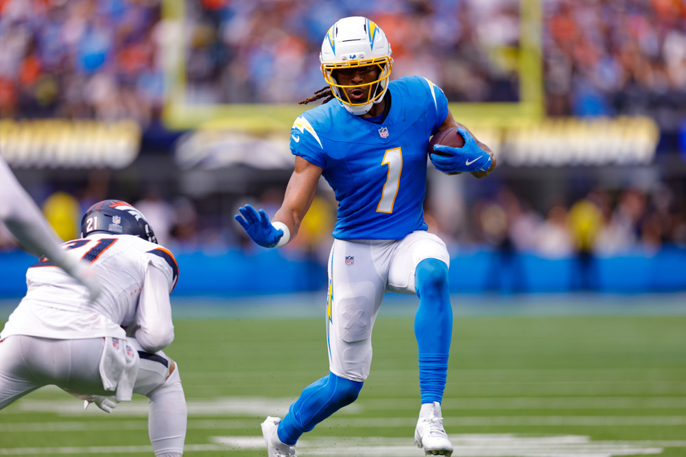 Quentin Johnsont LA Chargers featured in Breakout Wide Receivers for the 2025 NFL Season stiff arms a defender.