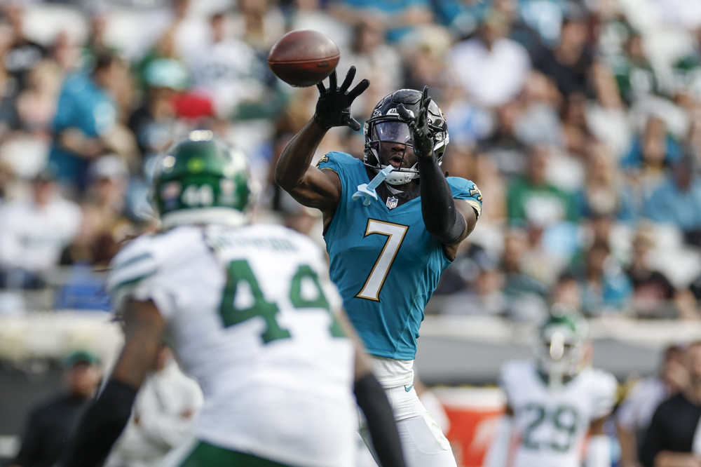 Brian Thomas Jr. Jaguars WR skies over a defender to high point the ball on his way to being featured in the Week 5 Fantasy Football Trade Advice Buy Low Sell High Targets