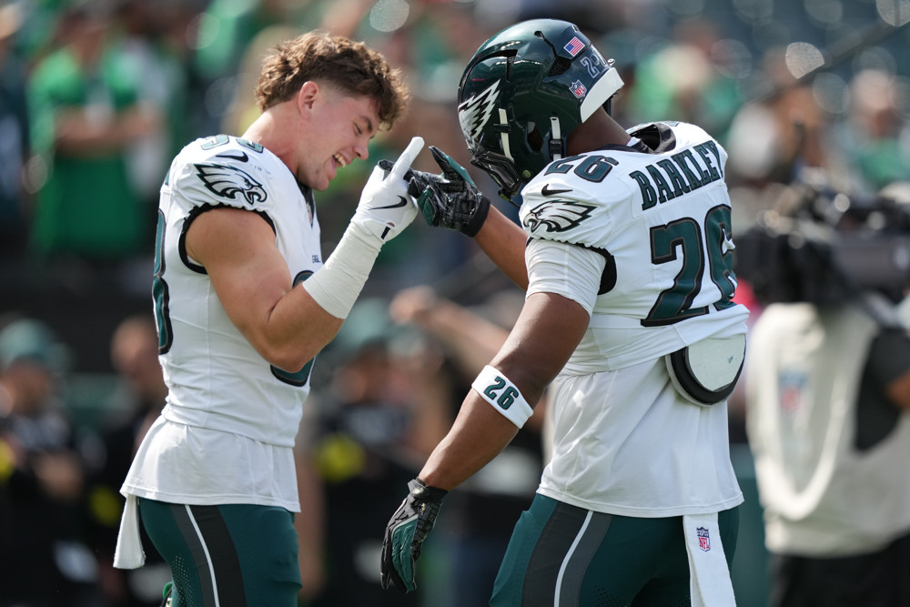 Cooper DeJean and Saquon Barkley fist bump as they are featured in the The Glossery Top 500 IDP Mixed Rankings SuperFlex TE Premium